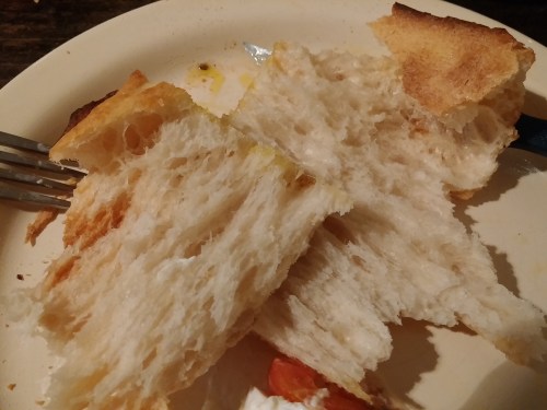 Pizza bianca torn open, showing its moliche - crumb or guts