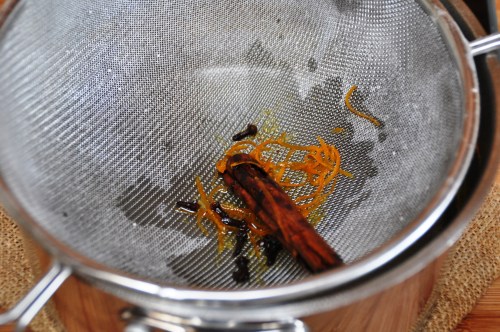 Revani - pour syrup over, straining out the spices