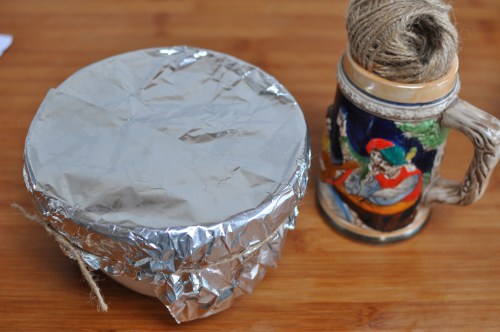 Seal the pudding basin with foil and string